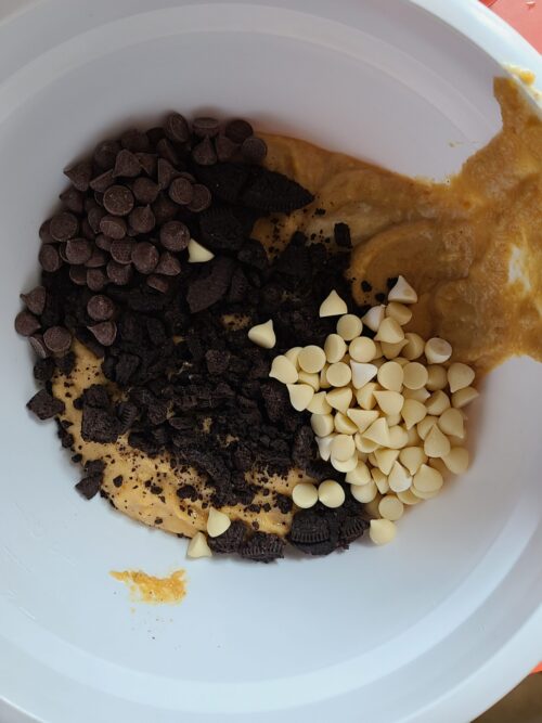 blondie batter with chocolate chips and cookies in a white bowl