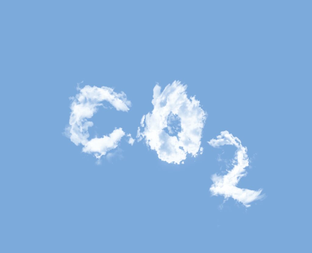 "CO2" is written in a cloudlike form against a blue sky.