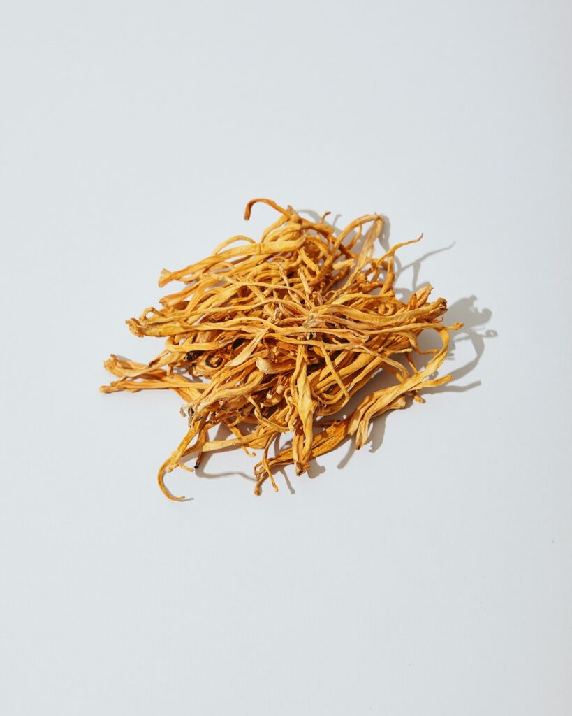 ayurvedic dried yellow flowers on a white background.