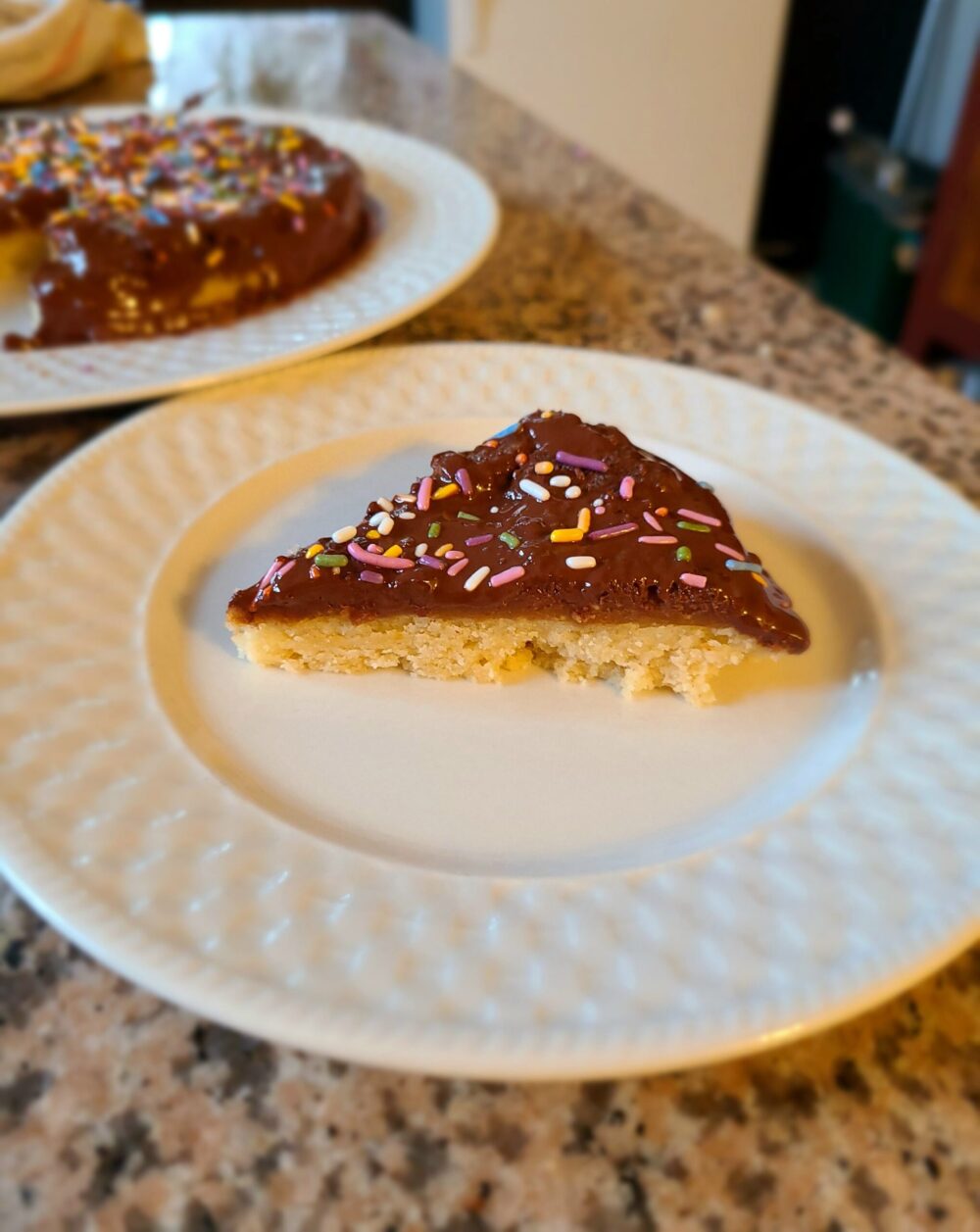 a slice of vegan peanut butter chocolate tandy cake on a white plate