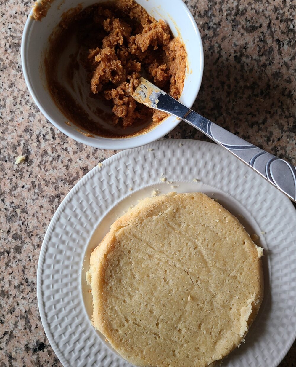vegan shortbread on a plate next to a bowl of peanut butter mixture