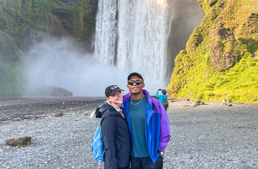 Skogafoss Iceland with man and woman smiling