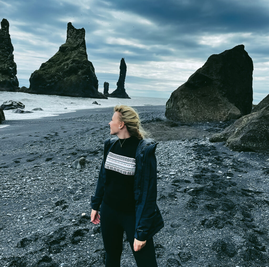 woman at black sand beach in southern Iceland